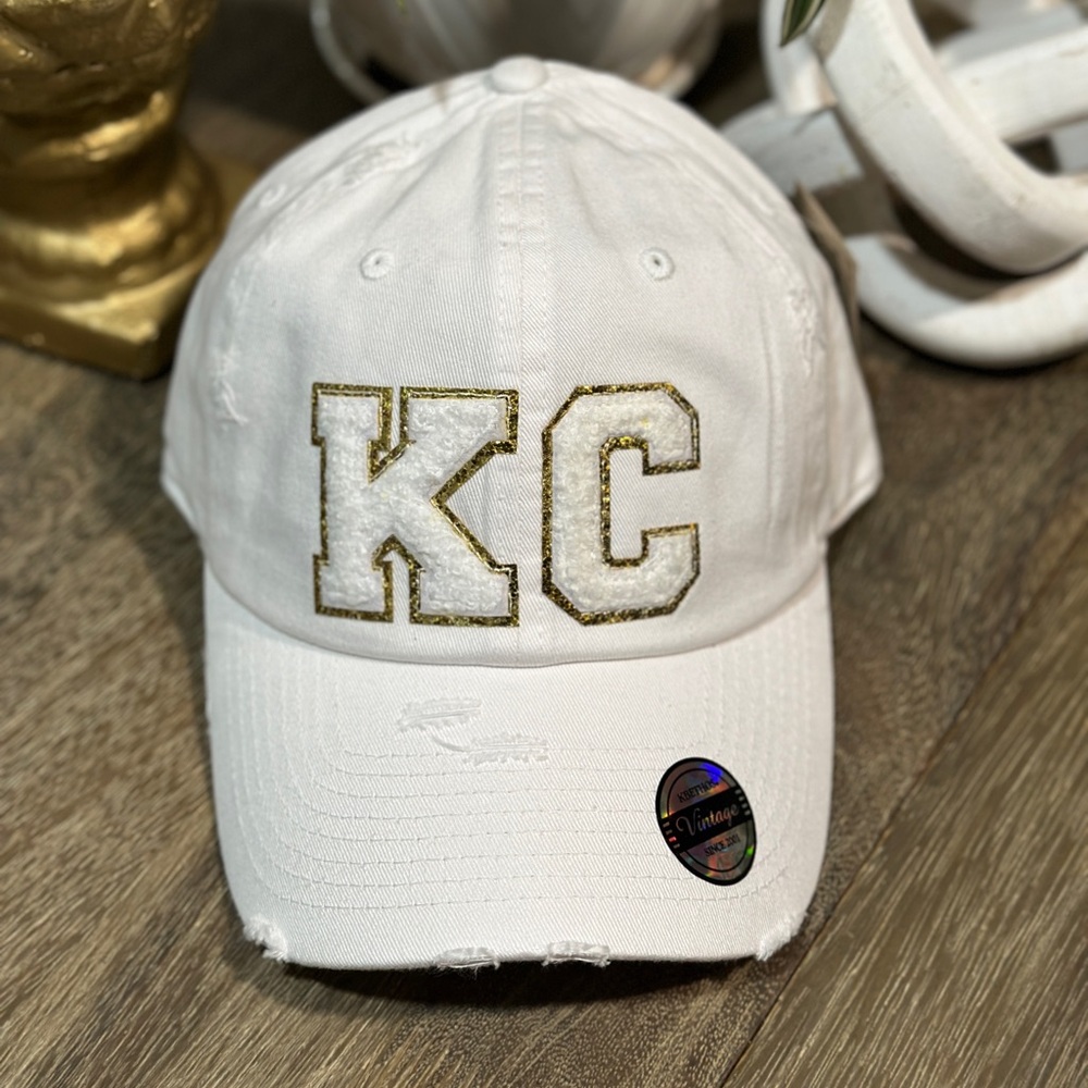 Super cute white KC hat with small white and gold chenille letters